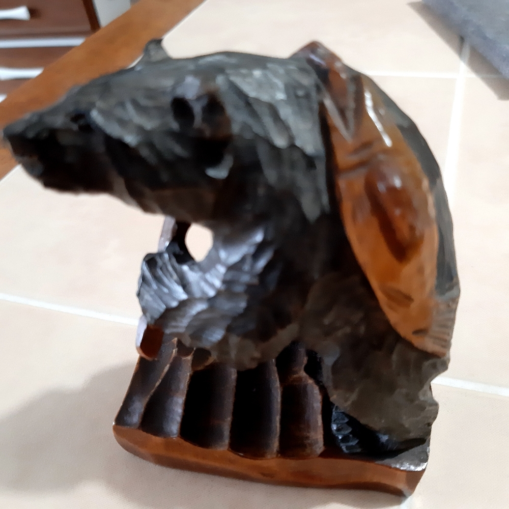 Hand carved wood bear carrying salmon